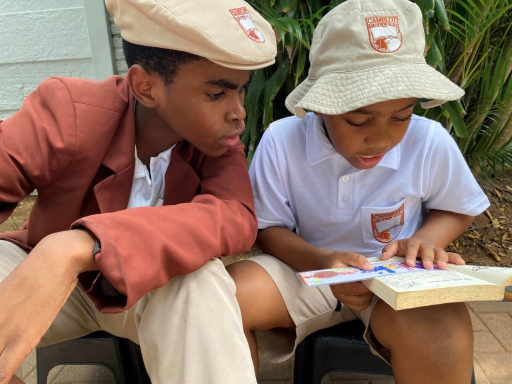 Learners and teacher in a small classroom at Camelot College